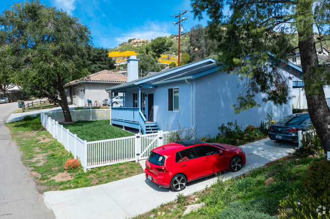 Smaller ranch styles homes in Harbison Canyon among large trees.