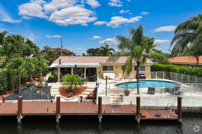 Coral Ridge Isles features waterfront properties with pools and lush landscaping.
