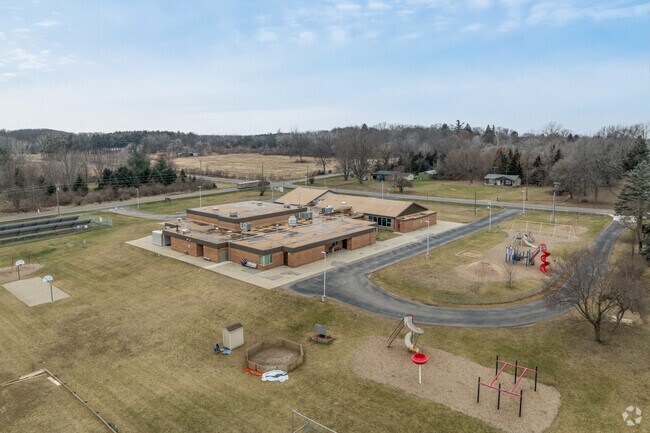 The rear view of Eureka Elementary School with the playground and track in view.