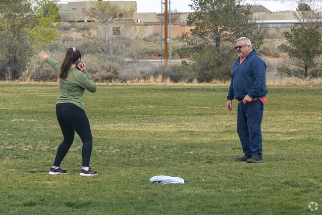A father teaches his daughter the shot put in Ladera Heights.