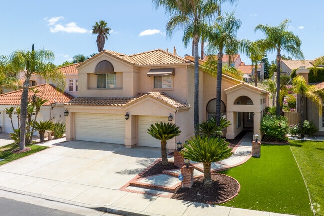 Enjoy manicured landscaping with various palm trees in Tuscany Hills.