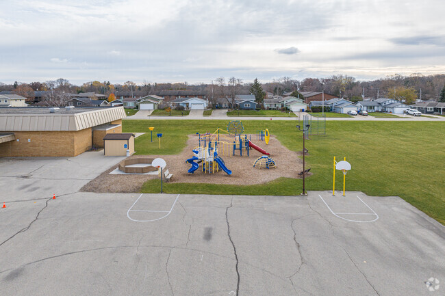 The playground at Jeffery Elementary School has basketball courts, slides & climbing structures.