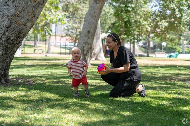 A joyful squeal echoed through the park as the baby spotted a truck near the park.