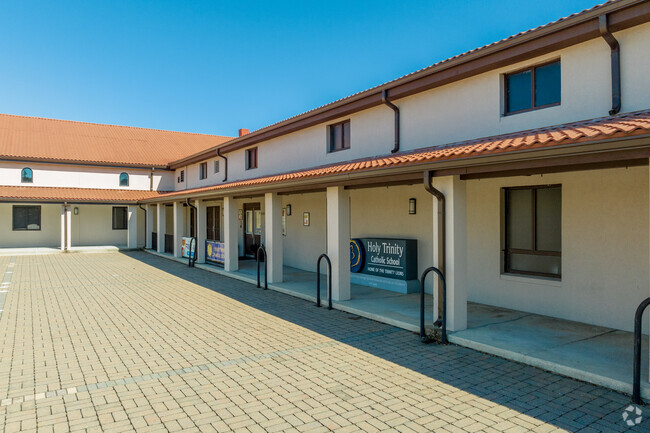 Holy Trinity Catholic School has a main entrance near the parking area.