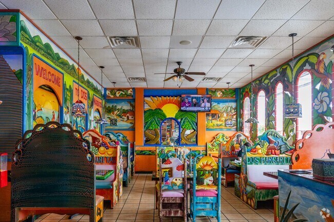 Dos Margaritas dining room is vibrant with many wall murals.