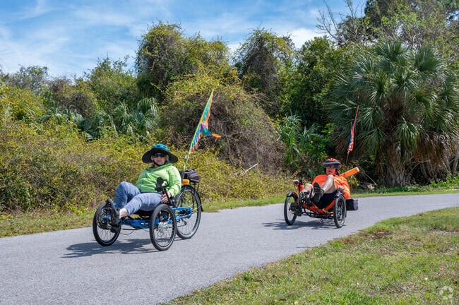 Tricyclists coast along on the Coastal Anclote Trail.