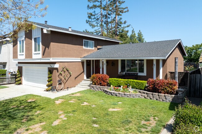 This Split-Level home in Hidden Glen South features a broad porch and well-kept raised garden.