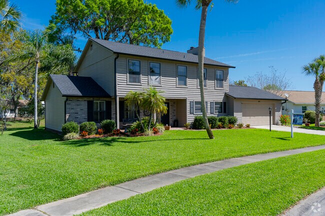 This Foxboro 2-story home features lush landscaping and curb appeal.