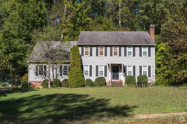 This classic colonial revival home in Atlee is symmetrical, gable roofs, and elegant dormers.