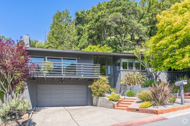This modern contemporary home is tucked into the tree filled hillside of Larkspur.