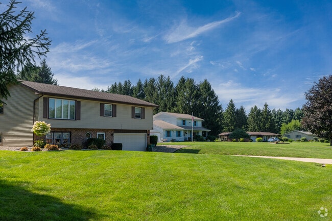Two-story split-level homes have large open grassy yards in Deep Run, Merrillville.