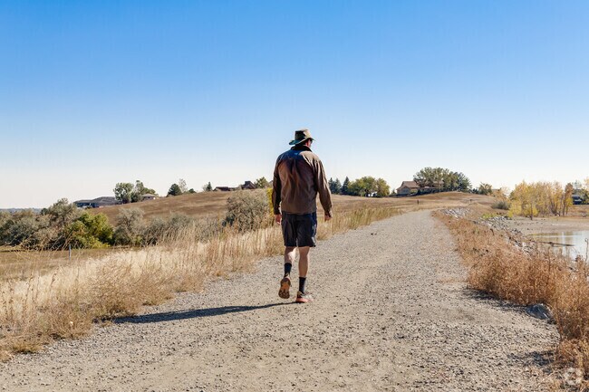 A Spring Mesa resident enjoys a peaceful walk on the Ralston Creek Trail by Tucker Lake.