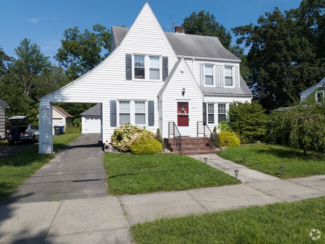A vinyl sided tudor styled home.