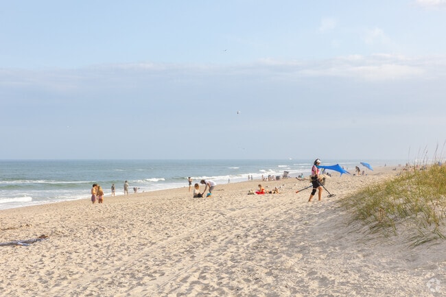 Beachgoers enjoy sandcastles and volleyball along Melbourne Beach’s scenic shoreline.