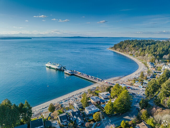 A scenic view of the ferry, Lincoln Park, and the Olympic Mountains.