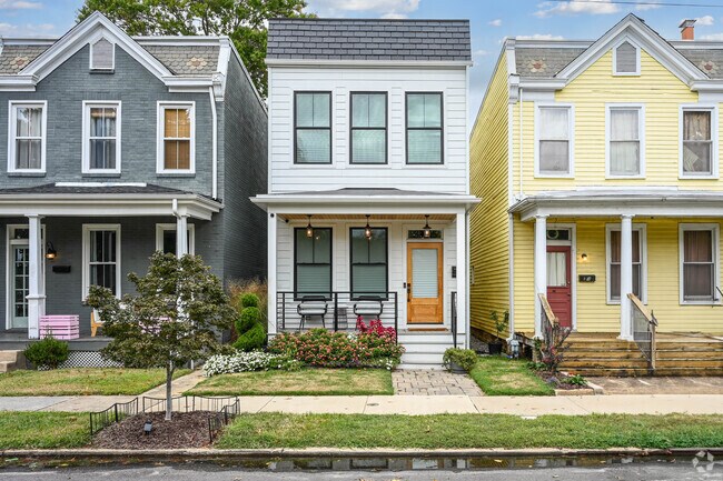 A row of charming two-story homes lines a neighborhood street in Stadium.