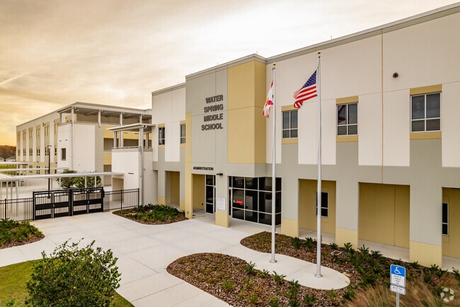Student walk through the entrance at Water Spring Middle School in Orange County.