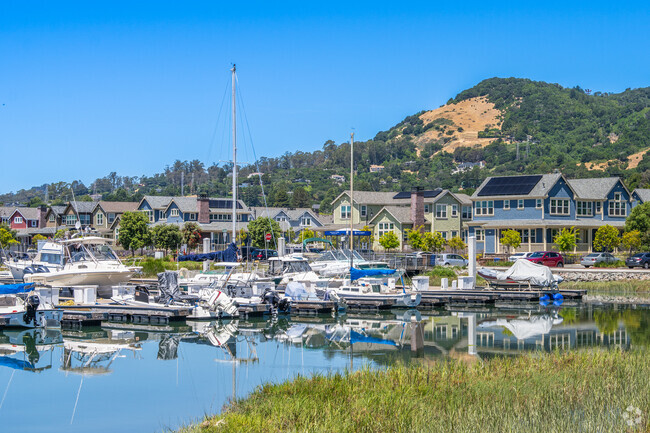 New homes line the harbor in Country Club with other homes in the hills directly behind them.
