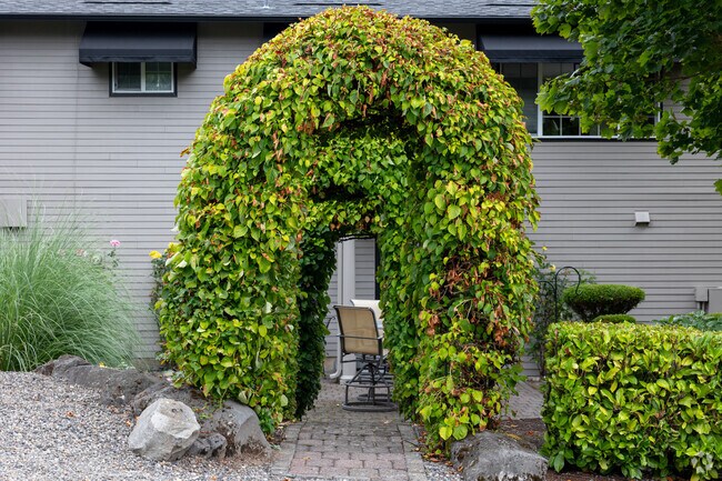 Perfectly manicured hedges lead to a seating area nearby homes in Riverview.