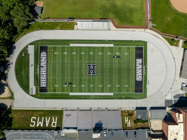 A green football field with navy blue details at Highland High School.
