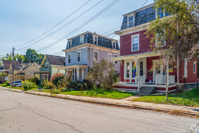 A row of homes in The Meadow portray the commonality of mansard roofs and French influence.
