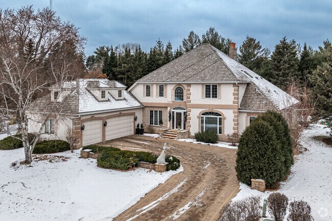 Select a newer Custom French Country-inspired estate home in the Fairview Southwest neighborhood.