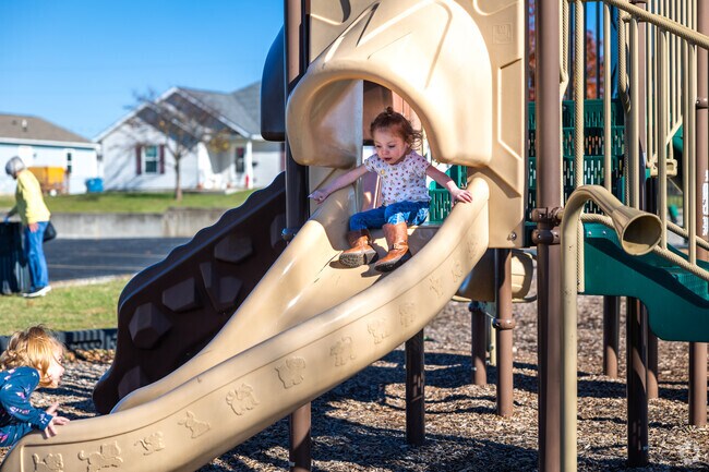 Kids love to go down the slide at Cunningham Park by Iron Gates.