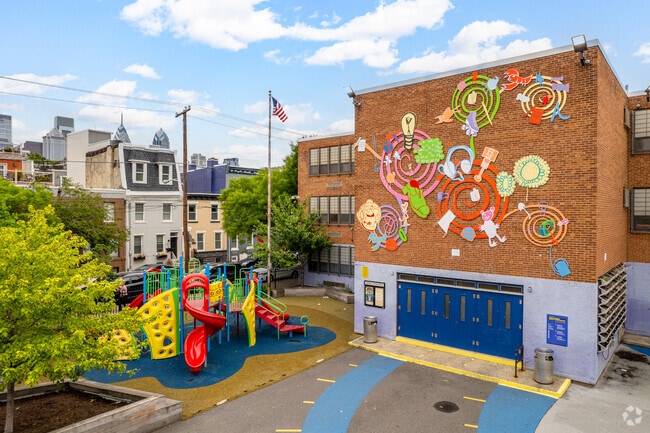 A vast playground rests outside the student entrance of Chester A. Arthur School.