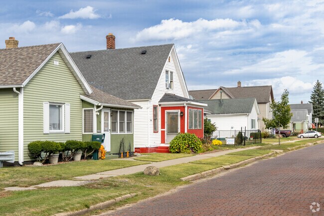 Gridded streets, including a few paved with brick, are lined with wood-sided bungalows.