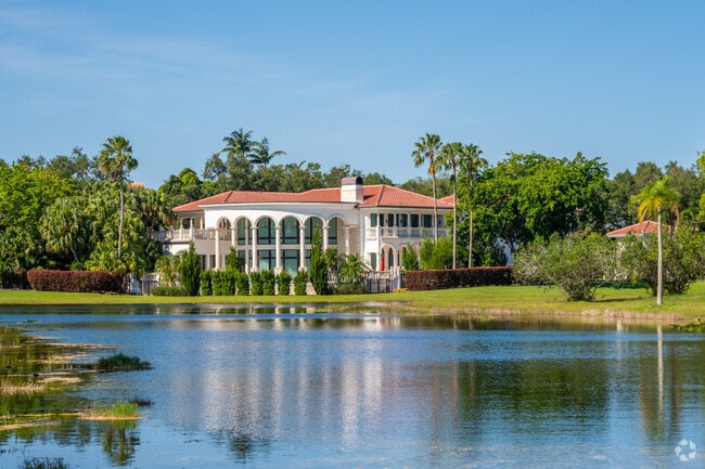 Large home Mediterranean styled home with large floor-to-ceiling windows Windmill Ranch Estates.
