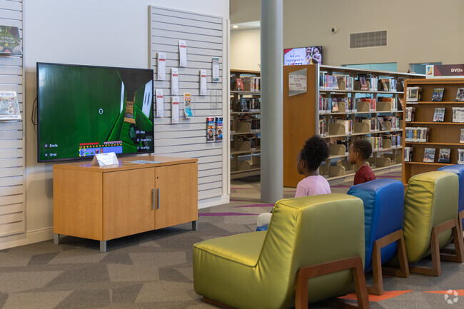 Youngs ones from Roosevelt enjoy games and reading at the local library after school.