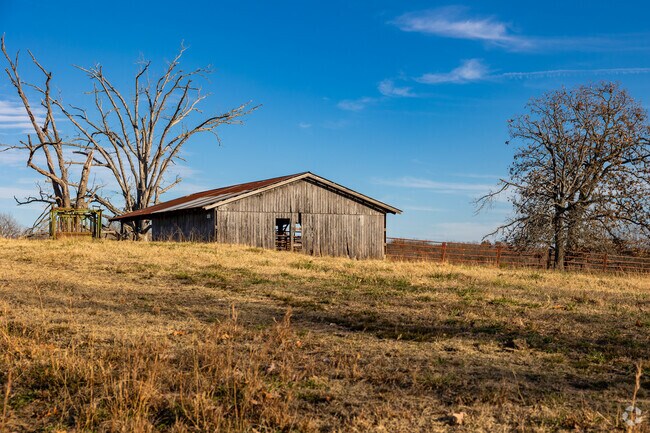An old barn sits in a field in West Outer Fayetteville.