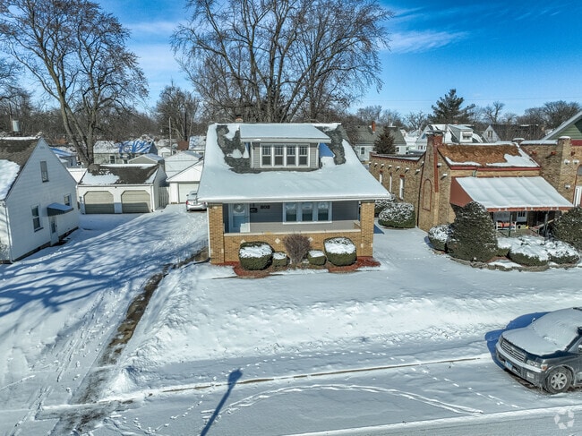 Four square bungalow style home with brick accents in West Bluff.