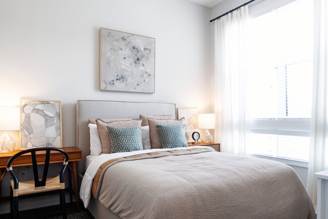 Upgrade Collection bedroom with large windows for ample natural light and hard surface vinyl plank flooring (Representative photo)
