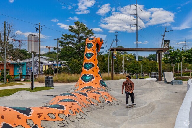The colorful serpent statue at the Railroad Square skateboard park shows the FAMU colors.