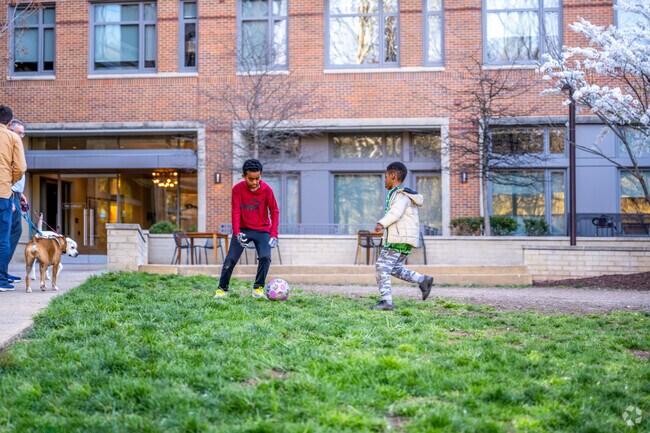 Kids play soccer outside of the Lindley apartment building in North Chevy Chase.