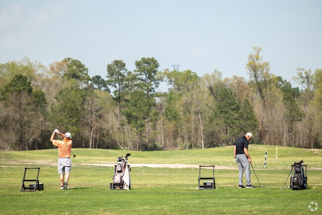 Golfers practice their swing at Kingwood Golf Advantage School in Kingwood.