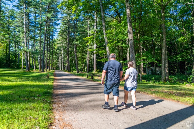 A couple takes a walk on a path at Moody Park, near East Side.