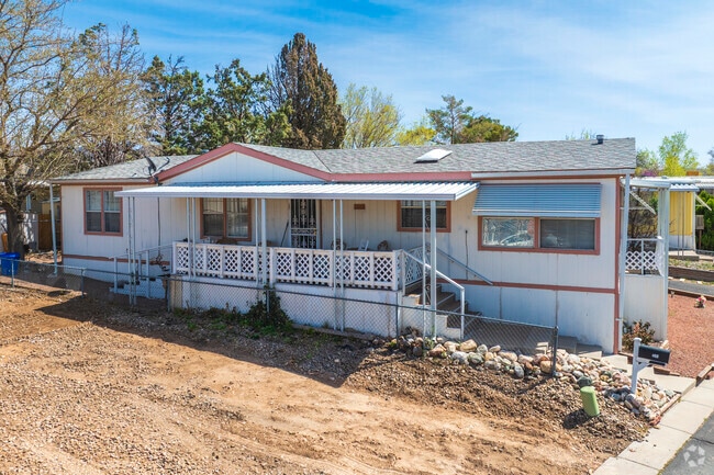 This home in Four Hills Mobile Home Park features a small front porch.