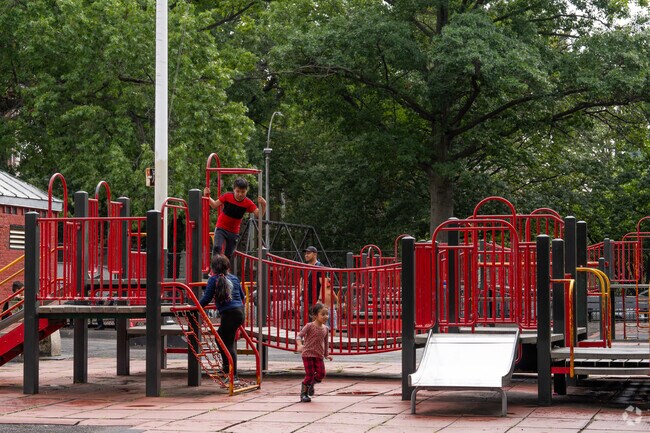 Kids run joyously at Garibaldi Playground in Bensonhurst.