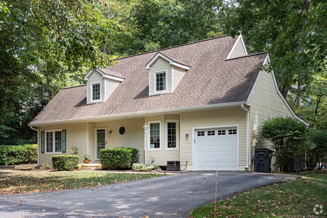 More traditional Cape Cod homes surrounded by trees in Wildewood Md.