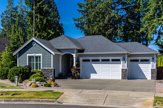 This lovely home in the Horizons neighborhood has two garages and craftsman styling.
