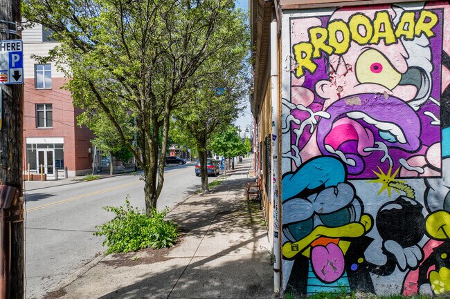 View of Butler Street next to a Jeremy Raymer mural in Lower Lawrenceville.
