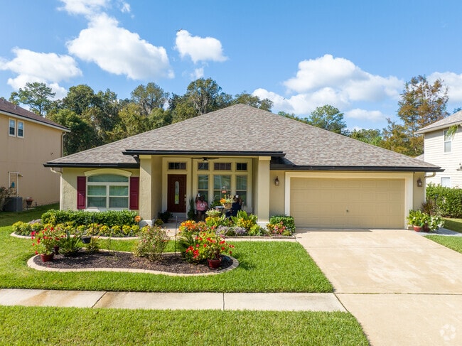 A couple enjoys coffee and the beautiful blooms in their front yard.
