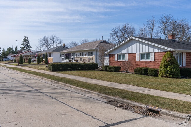 Sidewalks and small front yards flank the neighborhood streets in Wustum Park.