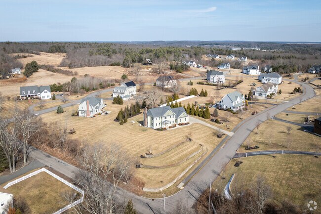 Take in the aerial views showcasing the charm of West Wrentham, MA, with its beautiful homes and spacious yards.
