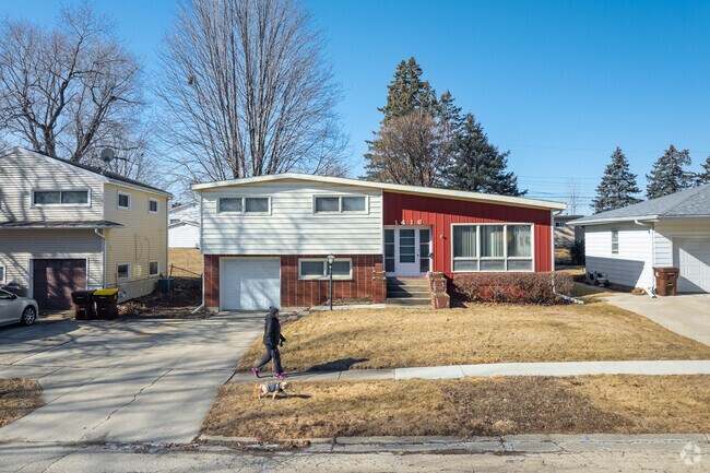 A resident walks past a split-level home in Freeport.