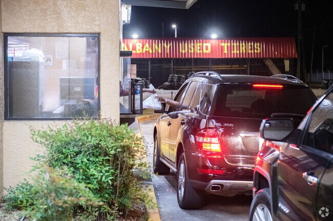 A great meal is passed at the pick-up window of Hip Hop Fish & Chips near Cleveland Heights.