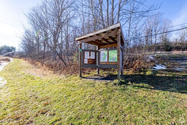 In Westford a small trail kiosk marks the entrance to Maple Shade Town Forest, offering maps and notes for hikers before they head into the woods.