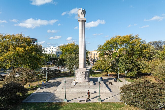 The Centennial Monument sits at the heart of the bustling roundabout of Logan Square.